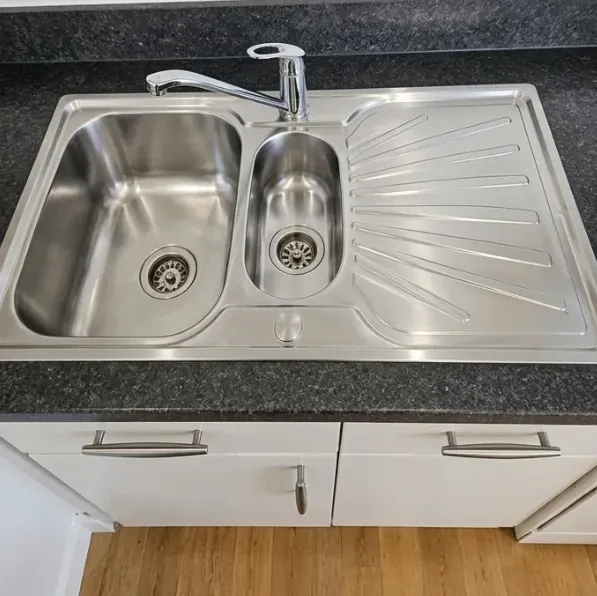 Stainless steel kitchen sink polished after cleaning
